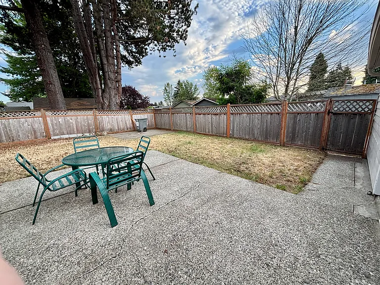 Fully fenced backyard with alley access and detached garage
