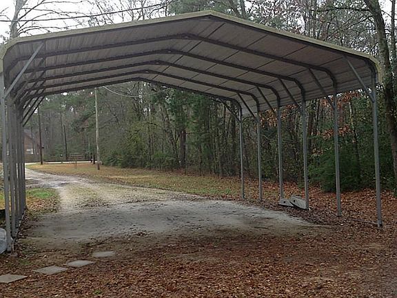 Extra tall carport on side of home