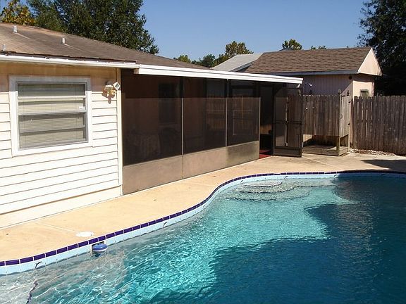 Rear of house with pool and screened patio