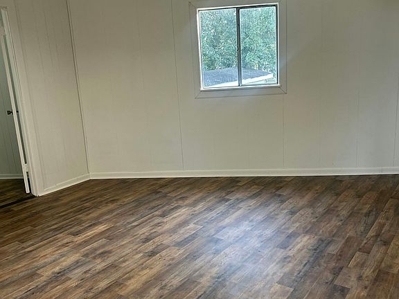 Cozy bedroom featuring a large window with beautiful courtyard views peaceful and inviting.