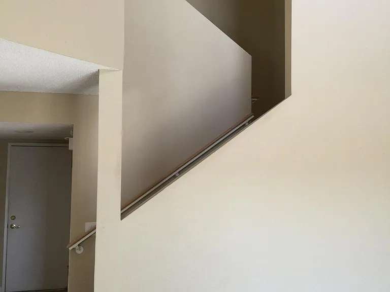 White door access to two-car garage and stair to second floor