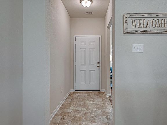 Entry leading to front door and formal dining to the right.