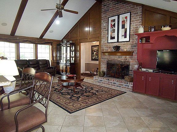 The heart of this home is the family room with dramatic cathedral ceiling and brick fireplace.