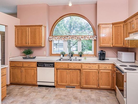 Kitchen features lots of natural light from the front windows above the sink and custom built cabinets with added shelving and a few convenient rollouts