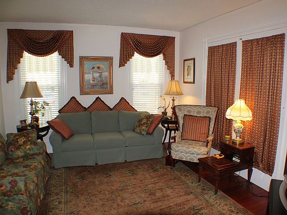 Queen size sleeper sofa in living room with flat screen HDTV and pocket doors