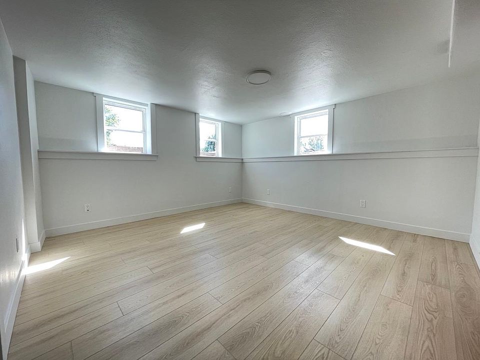 Bright living room. First bedroom is on the left and kitchen is to the right.