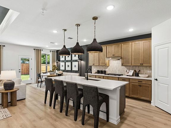 Large island overlooking gathering room and dining areas