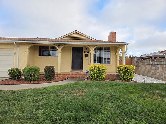 Front of the house with a 2-car garage and front lawn