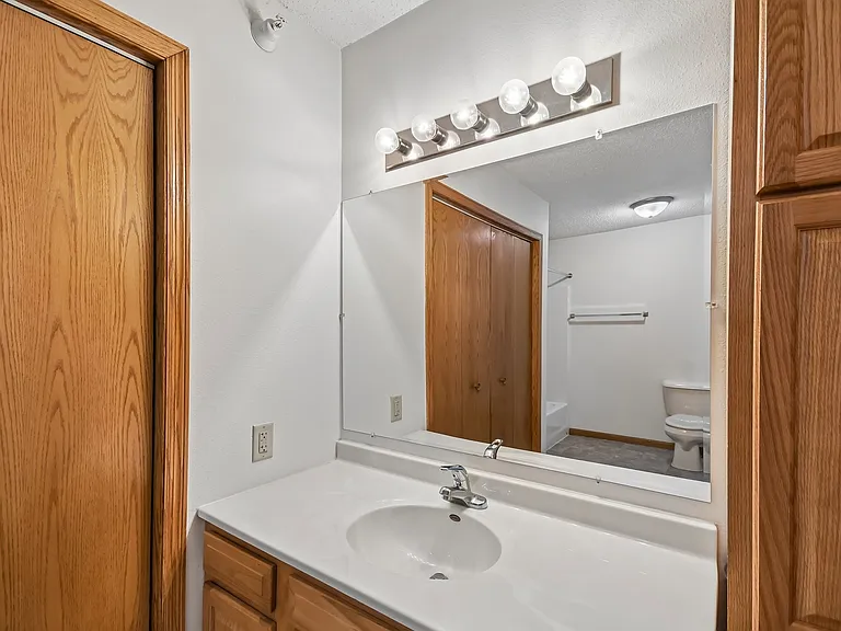 Elevate your living standards at Mill Pond Apartments with this stylish bathroom featuring modern fixtures and ample storage. Enjoy the blend of comfort and functionality that awaits you. Schedule a tour today and make this space your own!