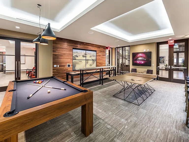 Game room featuring billiards and shuffleboard for relaxed recreation.