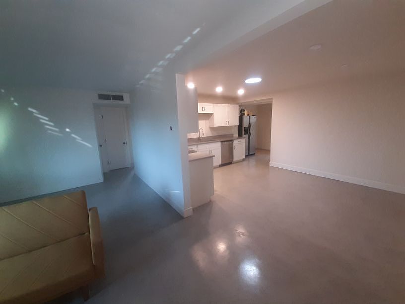 View of living room to dining area and kitchen