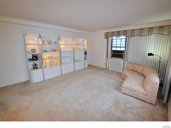 The large living room has both Southern and Eastern exposures and covered hardwood floors. There is 