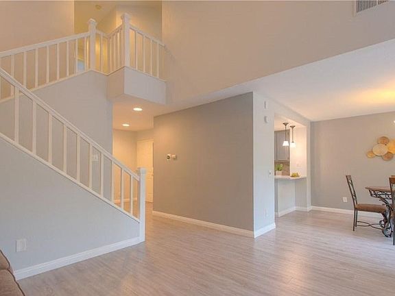 The staircase that leads to the three bedrooms and two restrooms; shows you the height of the ceilings. This is the view from the living room. The door in the corner is the front entrance.