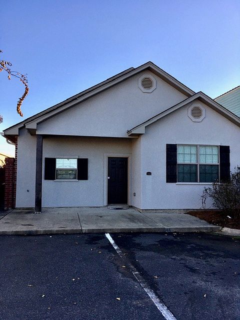 Front of house with two parking places.