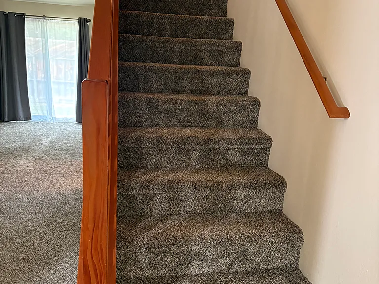 Stairs to upper loft area and second bedroom.