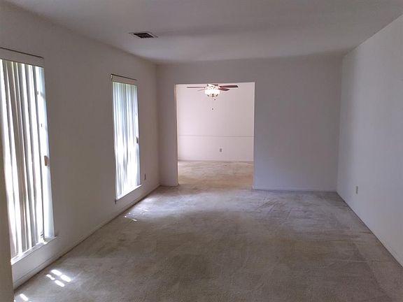 Picture of the formal living room and the dining room beyond.