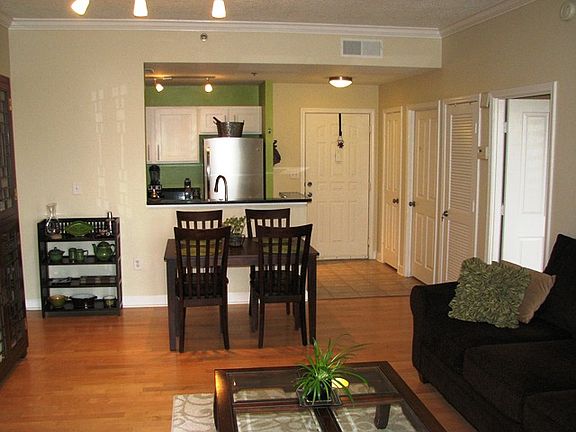 View from living room towards kitchen. Maple floors. Living opens to the balcony.