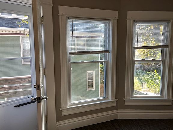 Large windows in the living room, elegant white trim around the new windows.