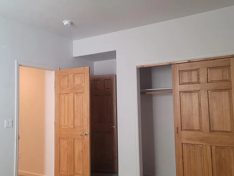 Back bedroom with two closets prior to new carpet