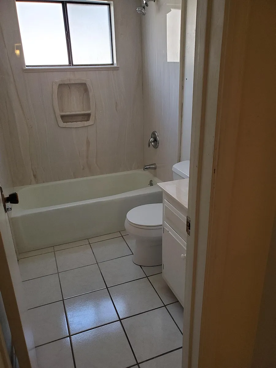 hall, complete bathroom has tub and shower, ceramic tile, vanity - 11519 Morocco Rd NE