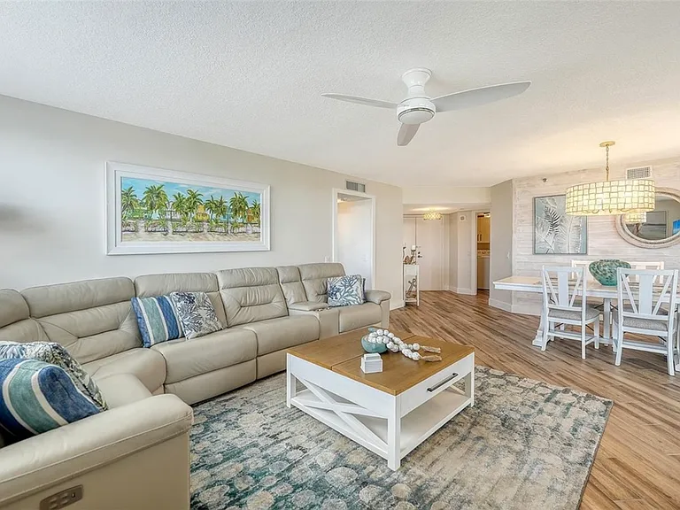 Spacious leather sectional with two corner recliners in this light bright family room with a large screen TV, open concept to Kitchen and dining areas.