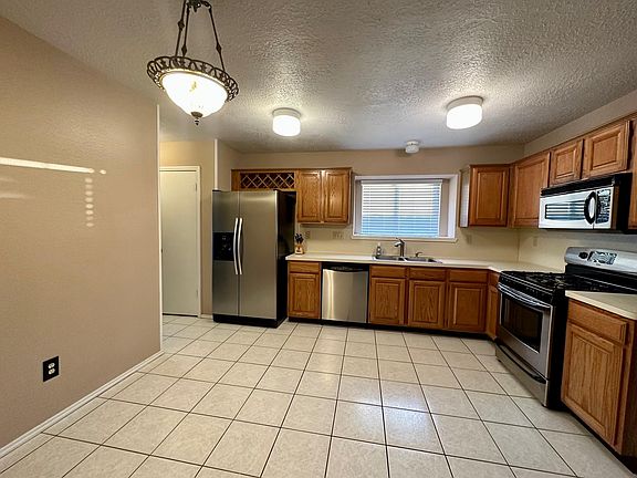 Kitchen with Bar, Gas Stove and Stainless Steel Appliances