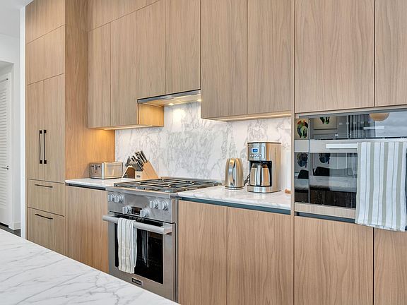 The kitchen is well stocked with dishes, glasses and cutlery