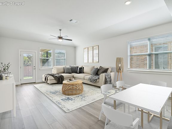 Virtually staged living room in the Sabine floorplan at a Meritage Homes community.