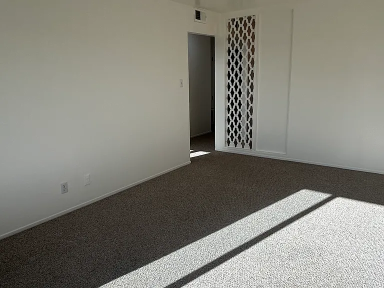 Entire apartment has been freshly painted throughout. Photo is of the living room. Adjacent room is the kitchen just to right-side of hallway.