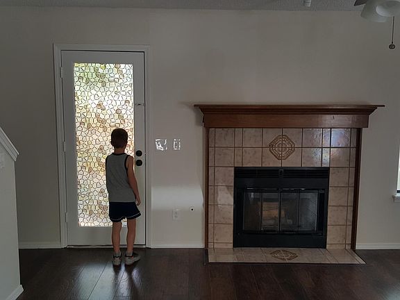 Large living room with Fireplace and NEW floors and fan!