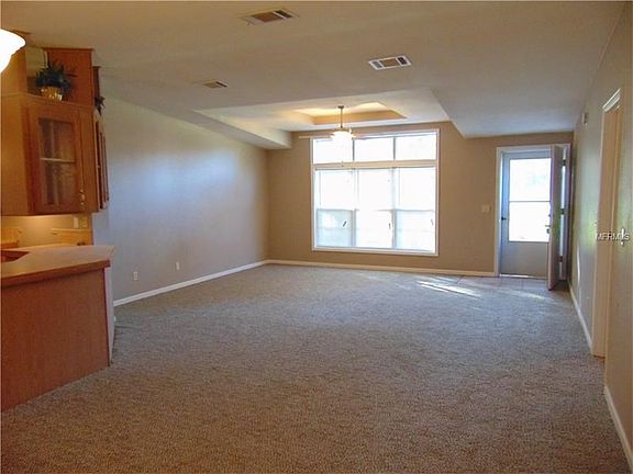 View of living room with tray ceiling