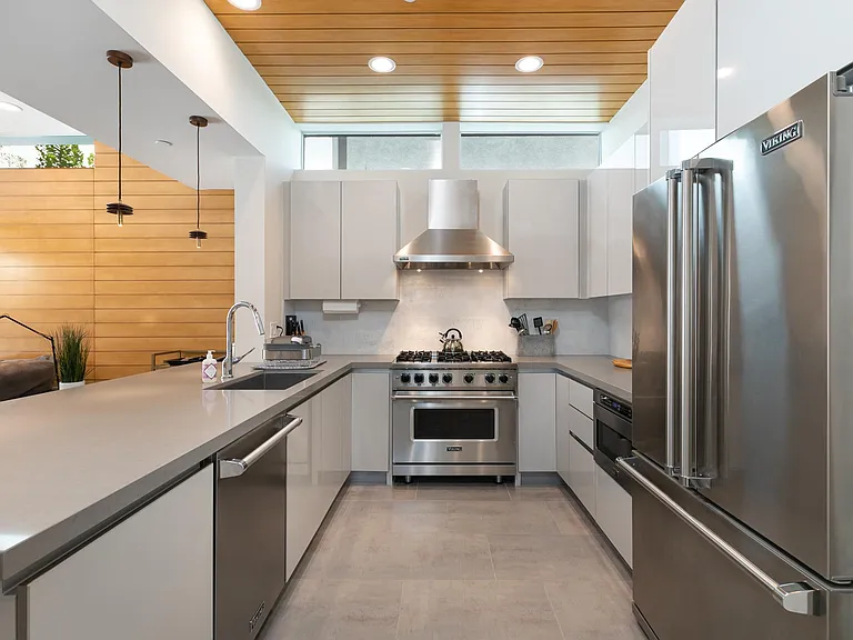 Kitchen with upscale Viking appliances including a gas stove, spacious fridge, dishwasher and microwave.