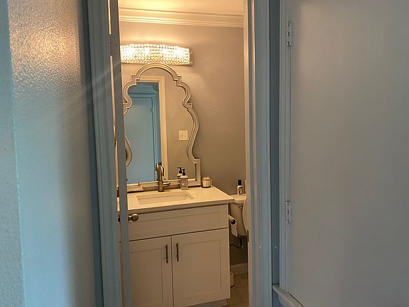 Downstairs 1/2 bathroom with new light fixture and modern mirror.