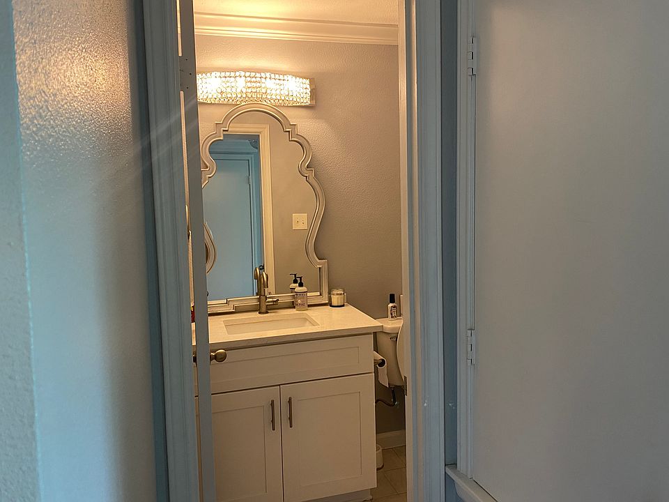 Downstairs 1/2 bathroom with new light fixture and modern mirror.