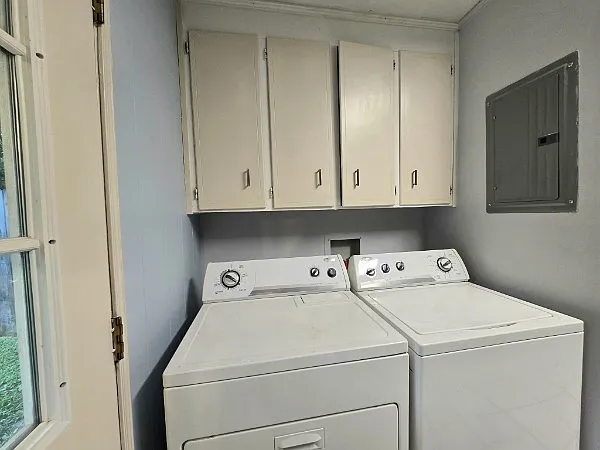 Laundry area with cabinet storage
