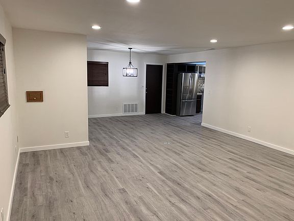 Living room with open dining area and connected kitchen.