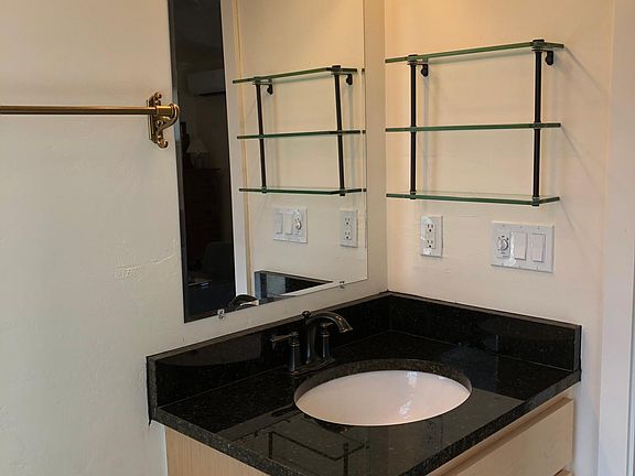 Granite top for maple vanity. Antique brass towel racks