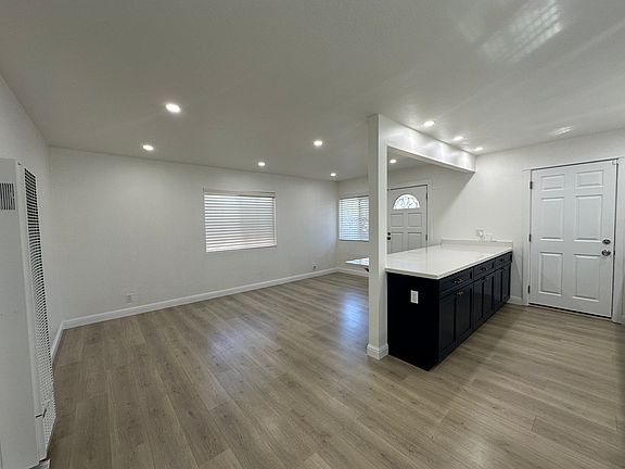 Bright & open layout with wide-plank floors and recessed LED lighting.