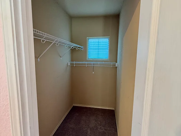 Walk in carpeted closet in 3rd bedroom