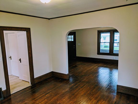 Dining room looking into living room and kitchen. The two doors in the kitchen lead to a pantry, and a large basement.