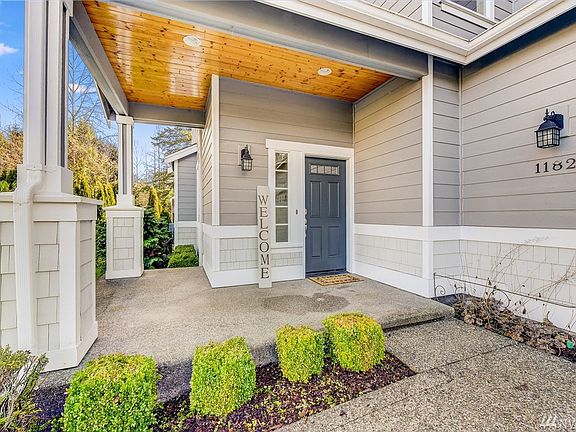 Charming front porch with wood soffit. Perfect for chairs or a porch swing.