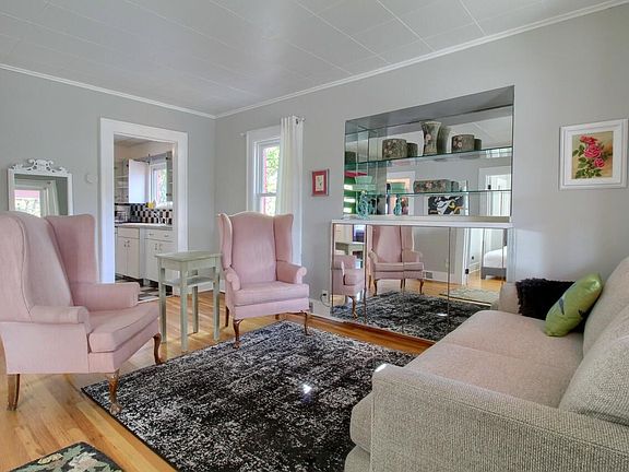 Furnished living room. Tv in cabinet.
Room has been painted to off white from gray. Furniture order is reversed.