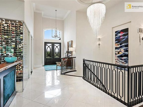 STUNNING FIRST IMPRESSION - IRON AND GLASS DOUBLE DOORS OPEN TO MARBLE FOYER