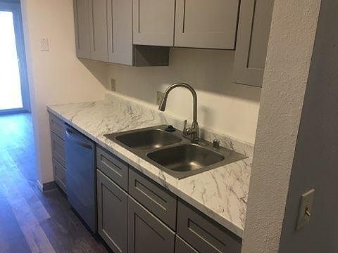Modern grey-accented kitchen ready to cook your favorite dish.