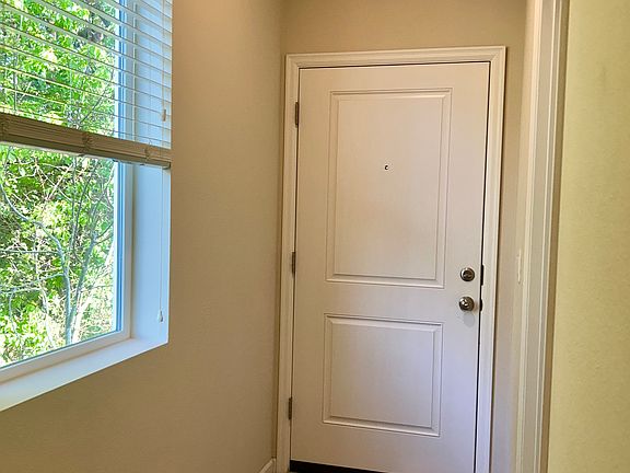 Entry door closed, with window to the side.