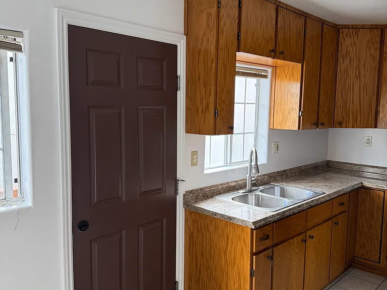 Kitchen custom cabinet showing door to balcony.
