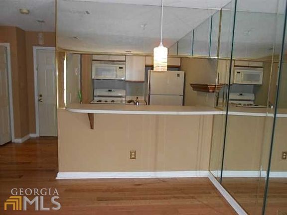 Kitchen includes breakfast bar and recent gas stove.