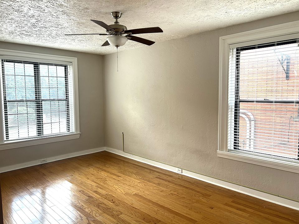 Gorgeous Sunlit Living room with beautiful hardwood floors and large windows.