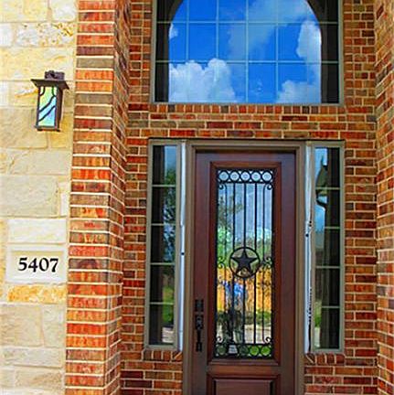Inviting 2 story entry with 3/4 lite glass and iron solid wood front door!