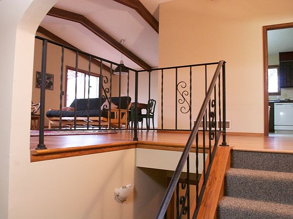 View from foyer. Hardwood floors, vaulted ceiling, exposed b